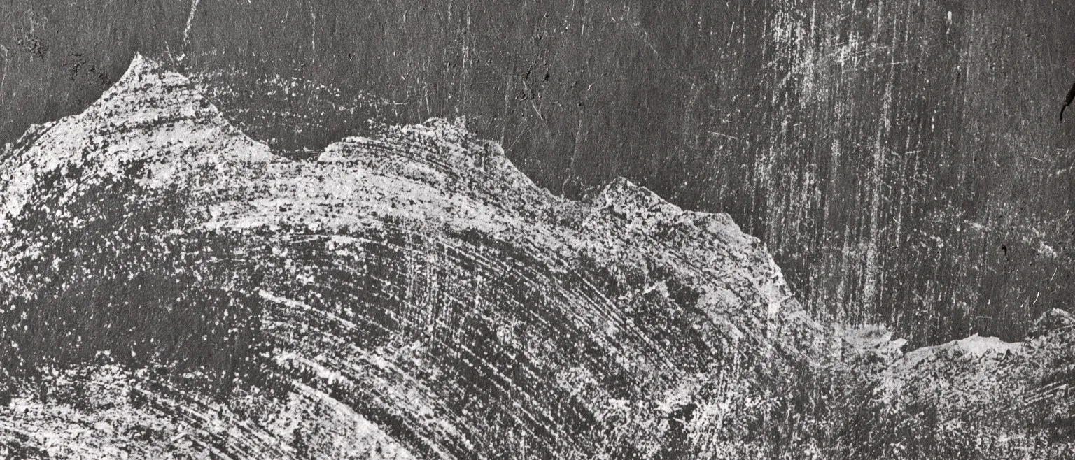 A pale crested wave of dry pigment against scored black.