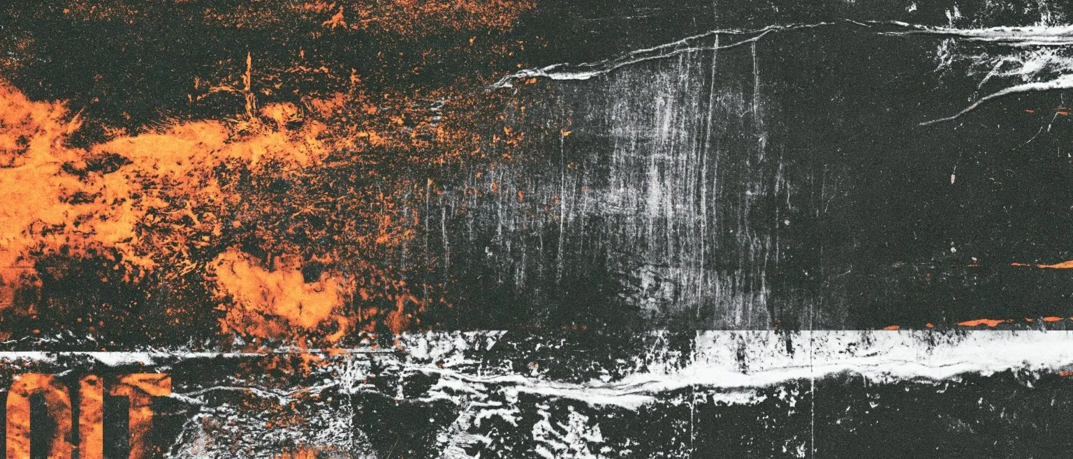 Orange corrosion spreading across a black and silver field.