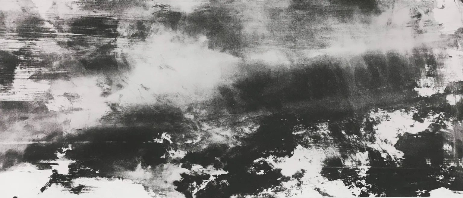 A soft grey band drifting over white, dark speckle below.