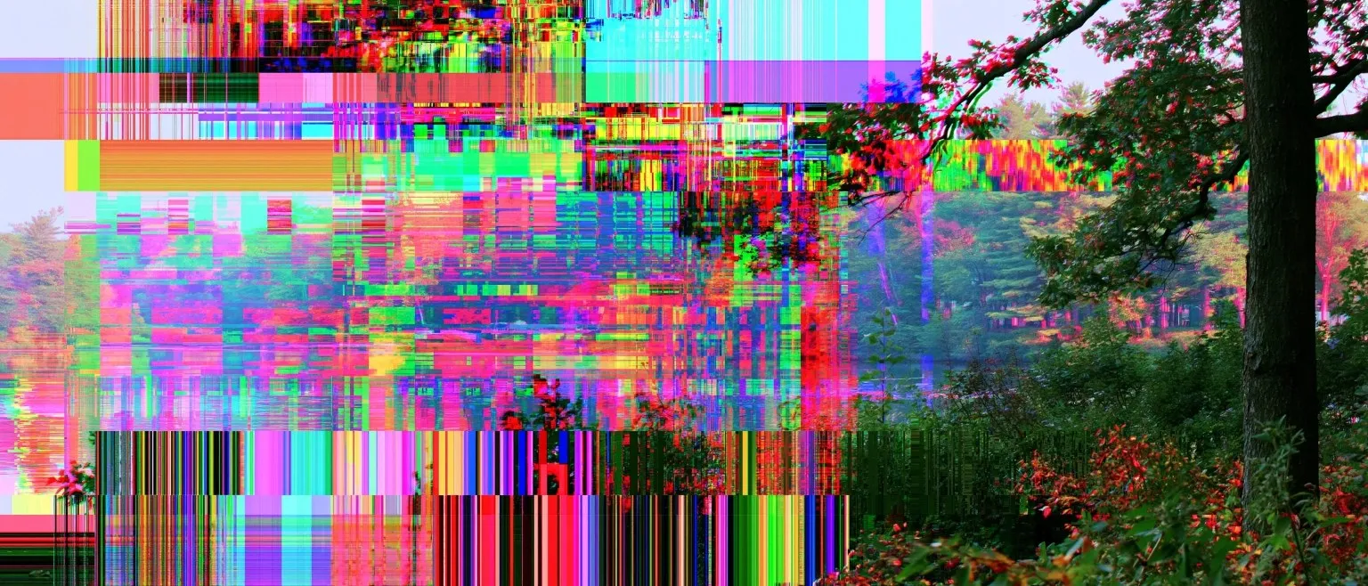 A lakeside tree scene torn into saturated glitch bands, red-leaved foliage visible at the lower right through the noise.