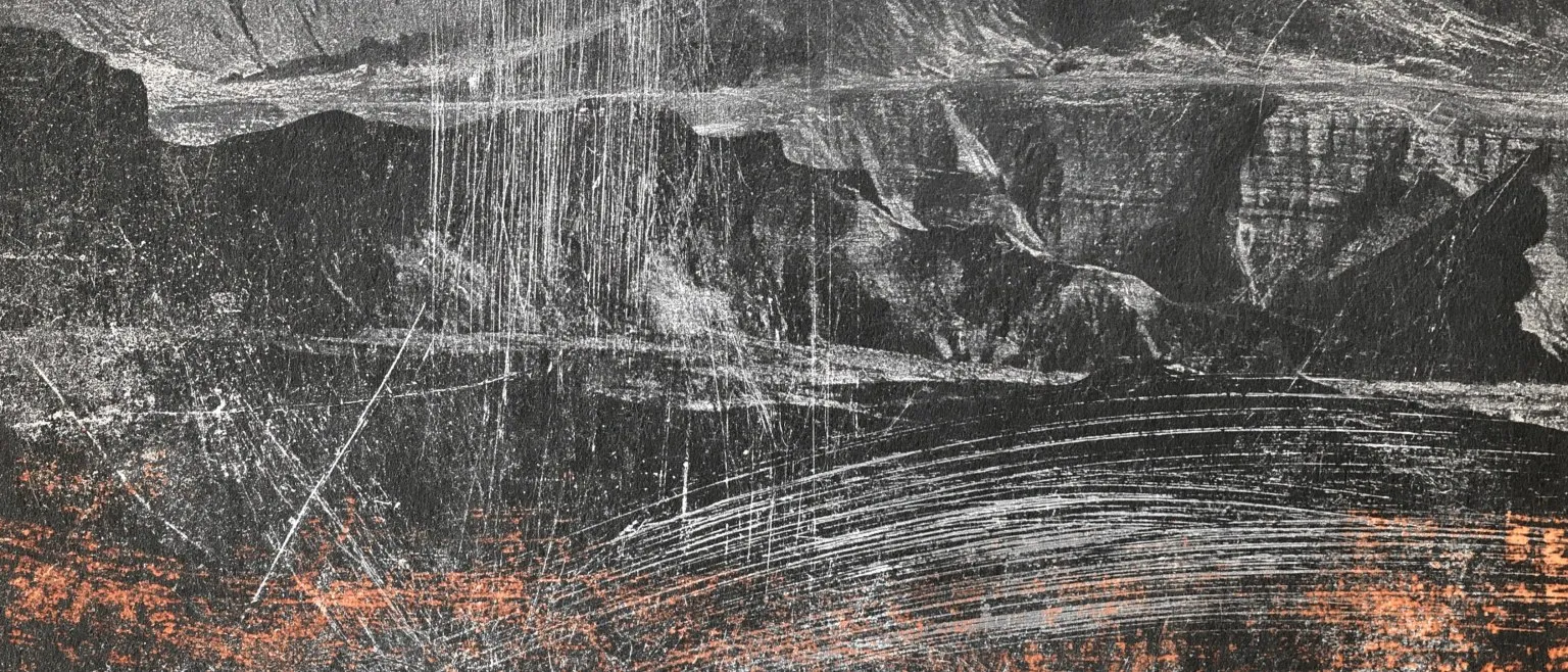 A pale ridge of dry scraping over black, orange flecks along the base.